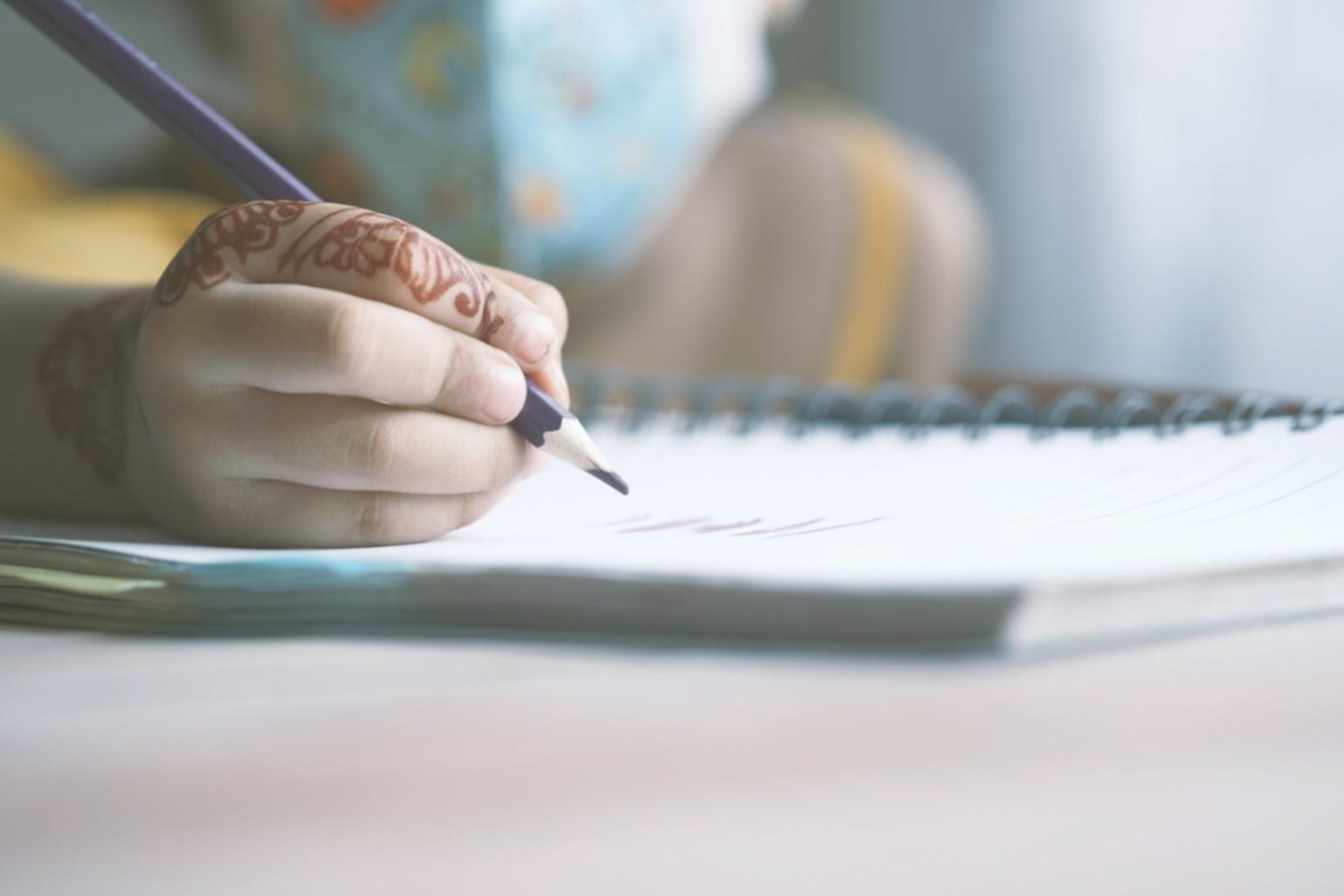 Student working on financial analysis with multiple screens showing market data and modeling software